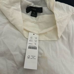 Woman’s cream turtleneck tank.